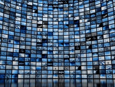 A large wall full of screens showing various images. Used as a concept for media regulation.