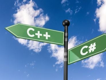 A pole with two diverging signs shaped like arrows with C++ and C# written on them. There is a blue sky and clouds in the background.