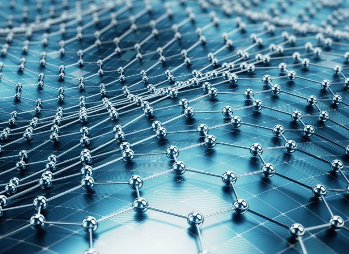 Illustration of grey molecules connected together in hexagonal shapes, over a blue surface. Used to represent the material graphene.