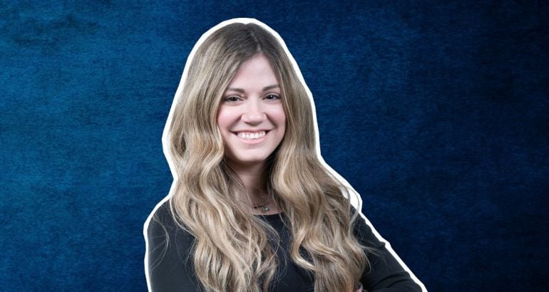 A headshot of a woman with long hair smiling at the camera against a blue background. She is Christina Gialleli.