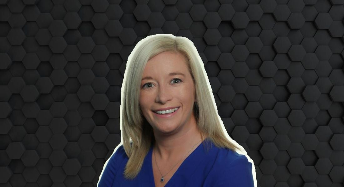 A woman with blonde hair smiles at the camera wearing a blue blouse. She is Kate Feeney, a senior manager at Fidelity Investments.