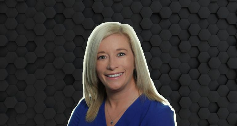 A woman with blonde hair smiles at the camera wearing a blue blouse. She is Kate Feeney, a senior manager at Fidelity Investments.