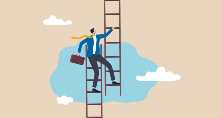 A person stands on the top of one ladder while stepping onto a different one, symbolising a career pivot.