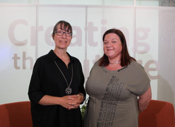 Two women stand side by side smiling at the camera. They are Ann O'Dea and Orla O'Sullivan.